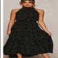 Black polka dot halter neck sleeveless tiered swing maxi dress worn by a model