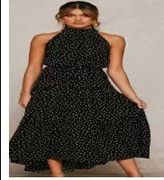 Black polka dot halter neck sleeveless tiered swing maxi dress worn by a model