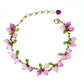 Pink berry cluster charm bracelet with enamel leaves and a lobster clasp shown on a wrist