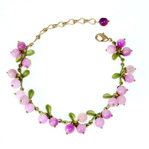 Pink berry cluster charm bracelet with enamel leaves and a lobster clasp shown on a wrist