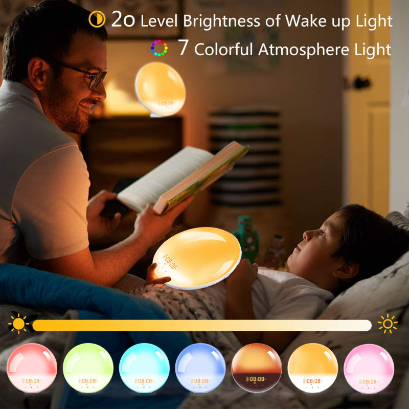 Man reading beside a child with the round wake-up light glowing warm in a dark bedroom