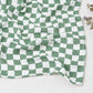 Large cotton muslin gauze baby blanket laid out, showing the loose breathable weave and print