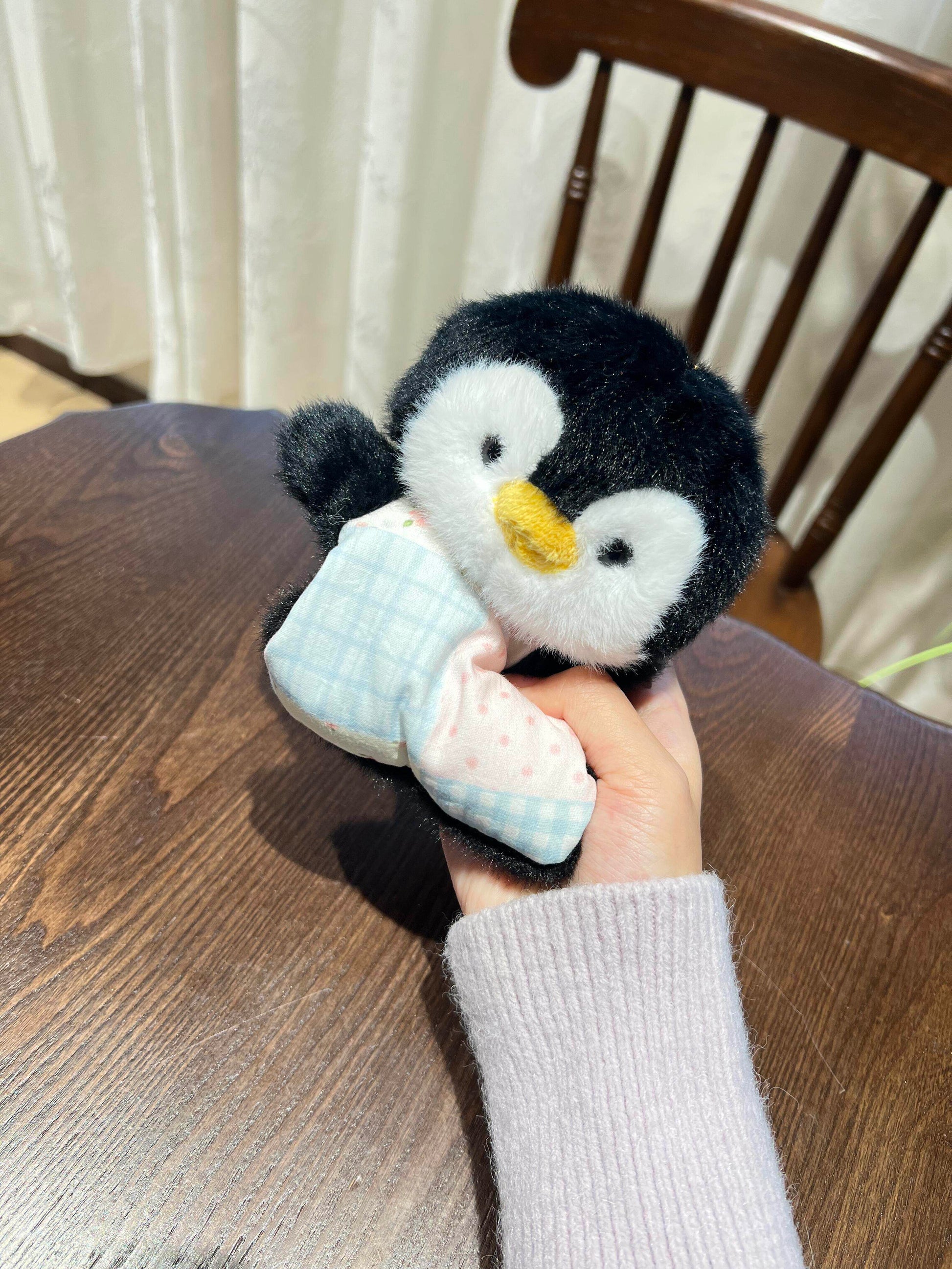 Small squishy bean bag plush animal toy on a shelf, gentle weight and cotton apron body
