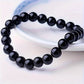 Rose quartz tiger eye bracelet worn on the wrist in a styled everyday scene