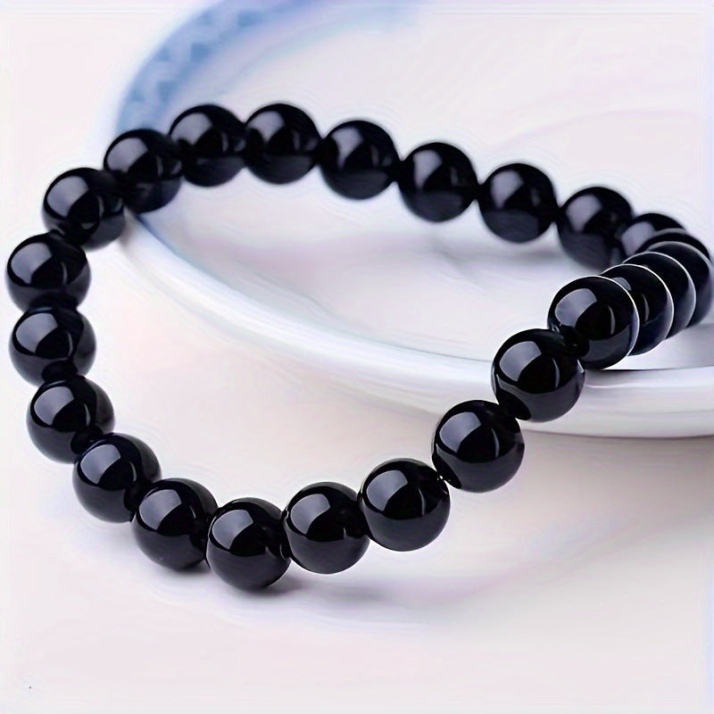 Rose quartz tiger eye bracelet worn on the wrist in a styled everyday scene