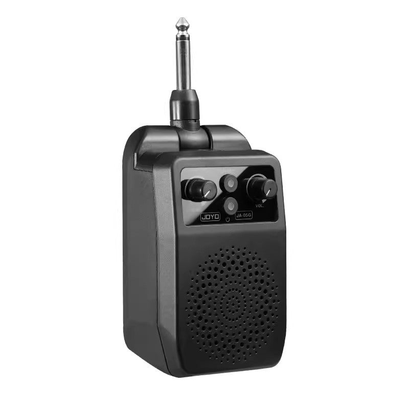 Black JOYO JA-05G plug in mini guitar amp shown from the front with the speaker grille