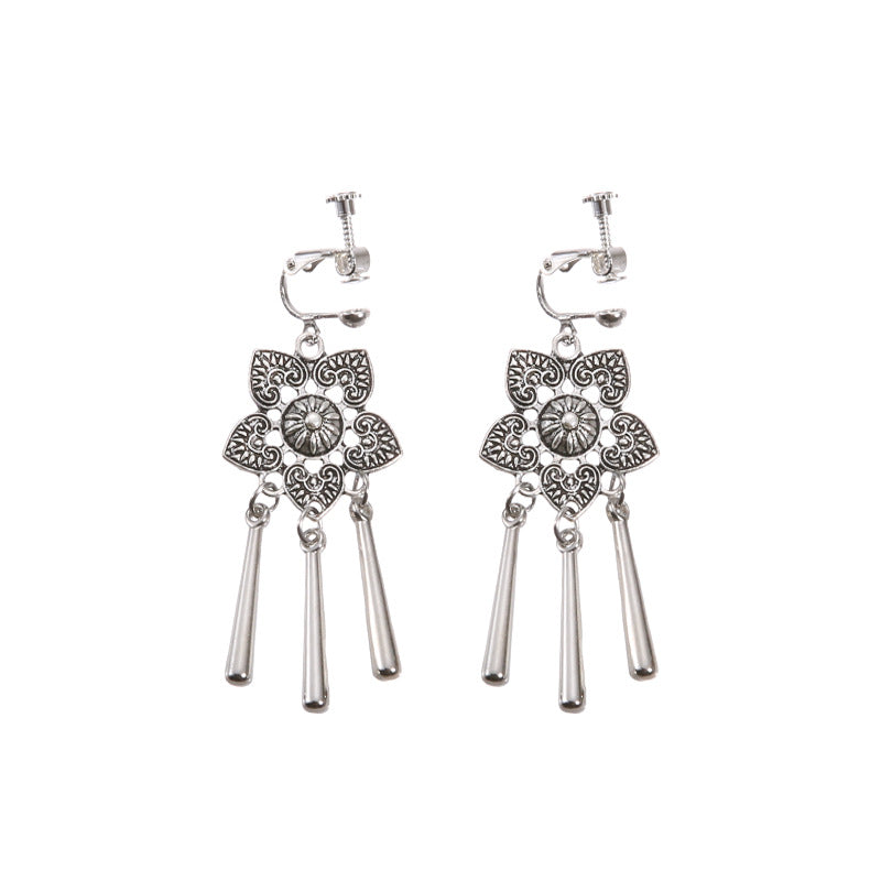 Bohemian tassel and bead clip-on drop earrings, aged tone zinc alloy frame, handmade pair on plain white background