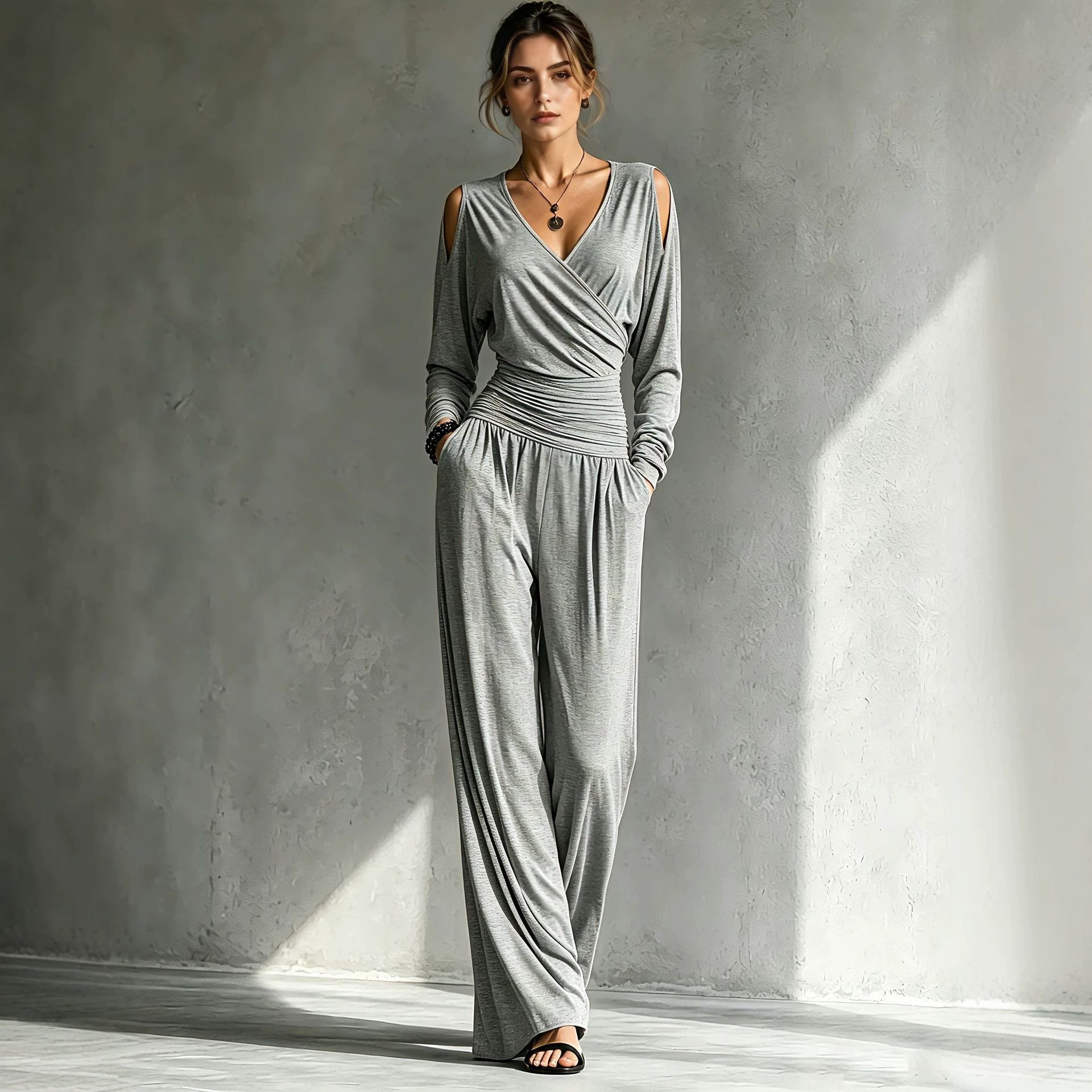 Open cold-shoulder detail under the long sleeve of the wrap jumpsuit