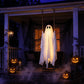 Glowing white ghost on a rope swing hung on a porch at night beside carved pumpkins and fog