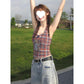 Plaid halter camisole top styled at an angle on a model