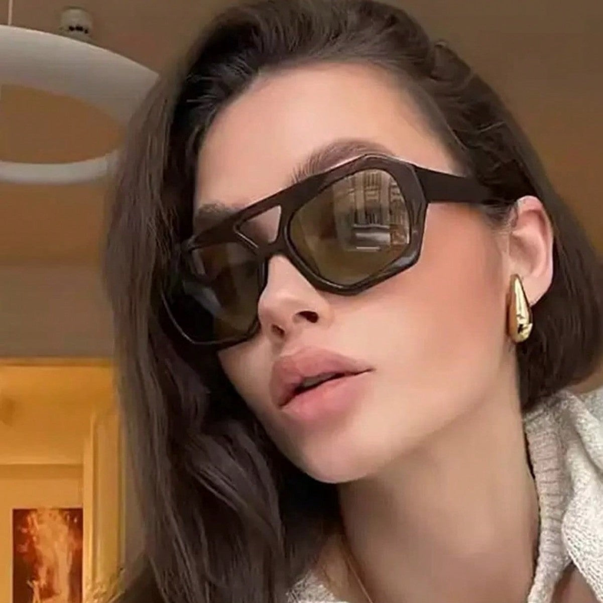 Retro polygonal sunglasses styled with a casual everyday outfit