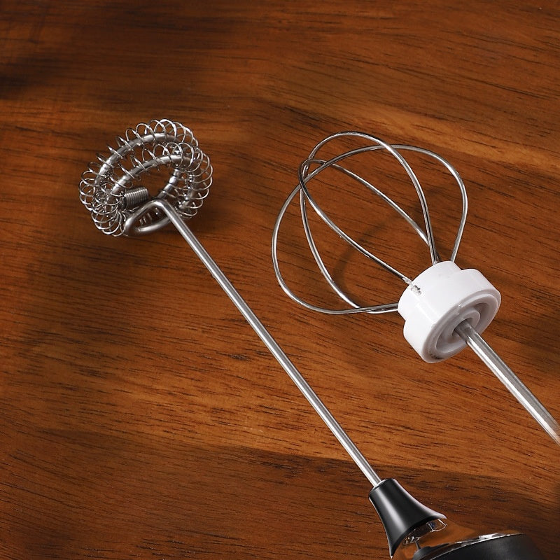 Close view of the coiled stainless steel whisk head of the milk frother