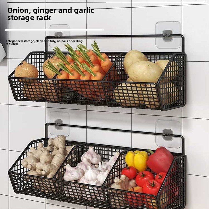 Wall mounted carbon steel wire mesh kitchen storage basket, mounted on a tiled wall holding onions garlic and ginger