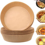 Stack of round natural wood pulp air fryer paper liners beside fried food in a basket
