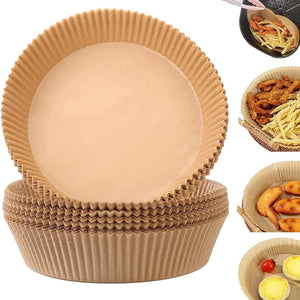 Stack of round natural wood pulp air fryer paper liners beside fried food in a basket