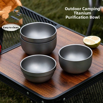 Three grey frosted stainless steel double wall bowls stacked on an outdoor table