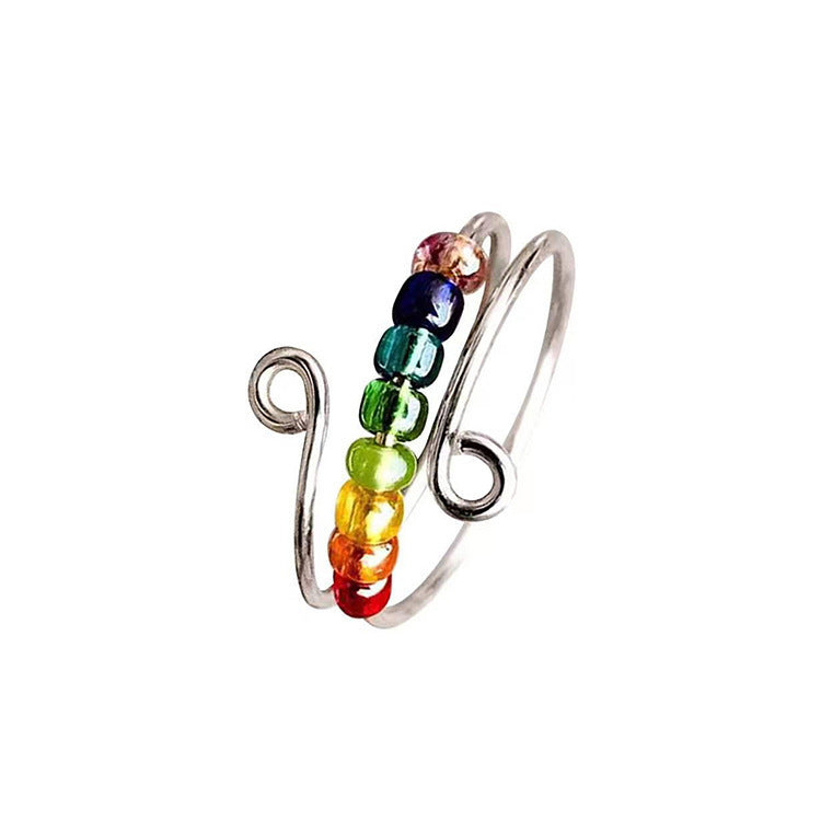 Polished spinner bead ring worn as an adjustable unisex everyday fashion piece