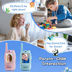 Mother and son using a pair of pink and blue video walkie talkies at home with faces on the 2 inch screens