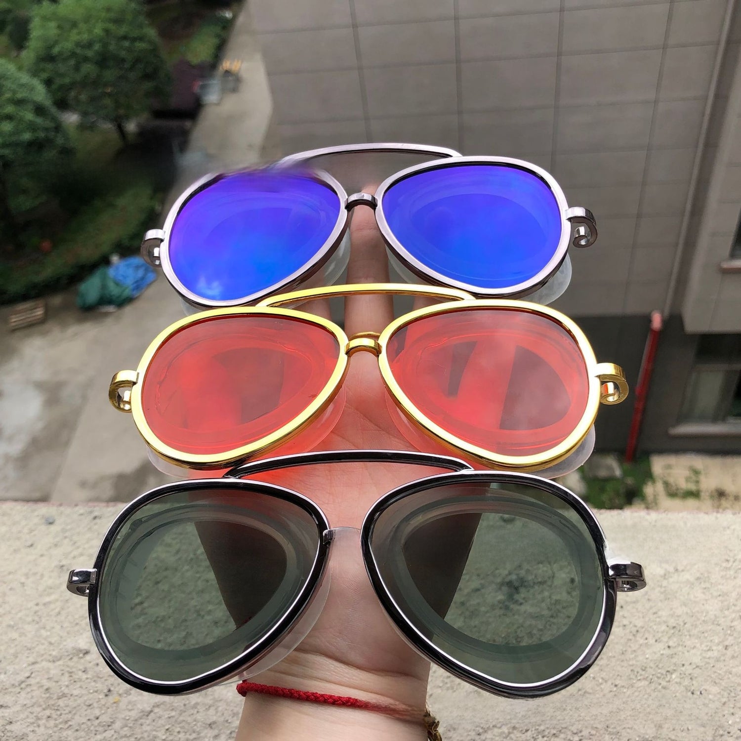 Red mirror aviator swim goggles sealed in a blister pack with feature icons