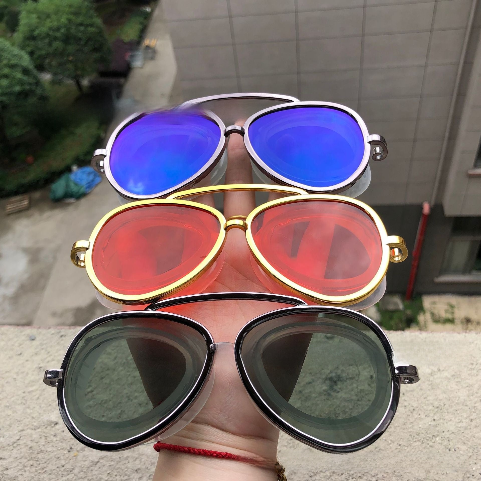 Red mirror aviator swim goggles sealed in a blister pack with feature icons