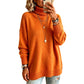 Woman in an orange turtleneck knit sweater with ribbed cuffs and hem on a white background