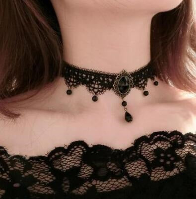 Vintage lace choker necklace displayed on a neck form against a plain backdrop