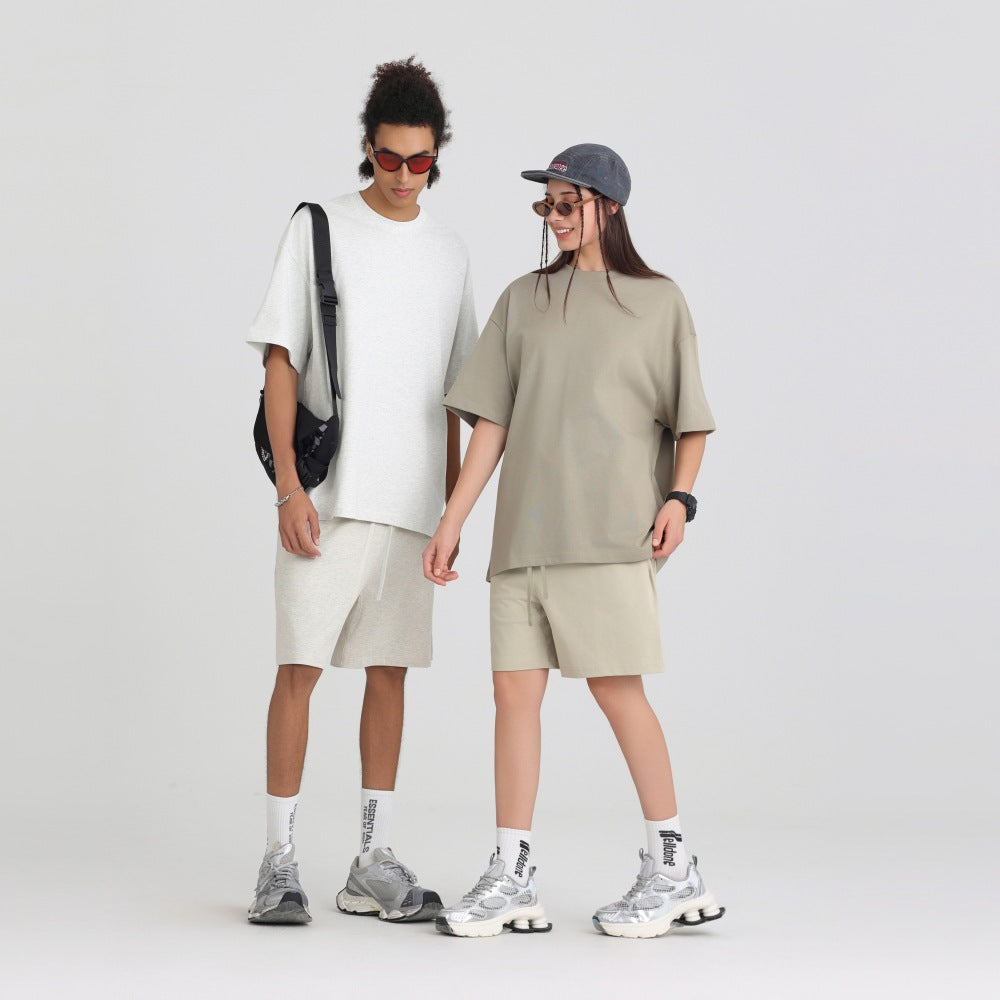Flat lay of the heavyweight 305g cotton crew neck tee showing the boxy oversized cut and ribbed collar