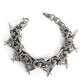 Close up of the linked metal rings and cone spikes of a punk bracelet