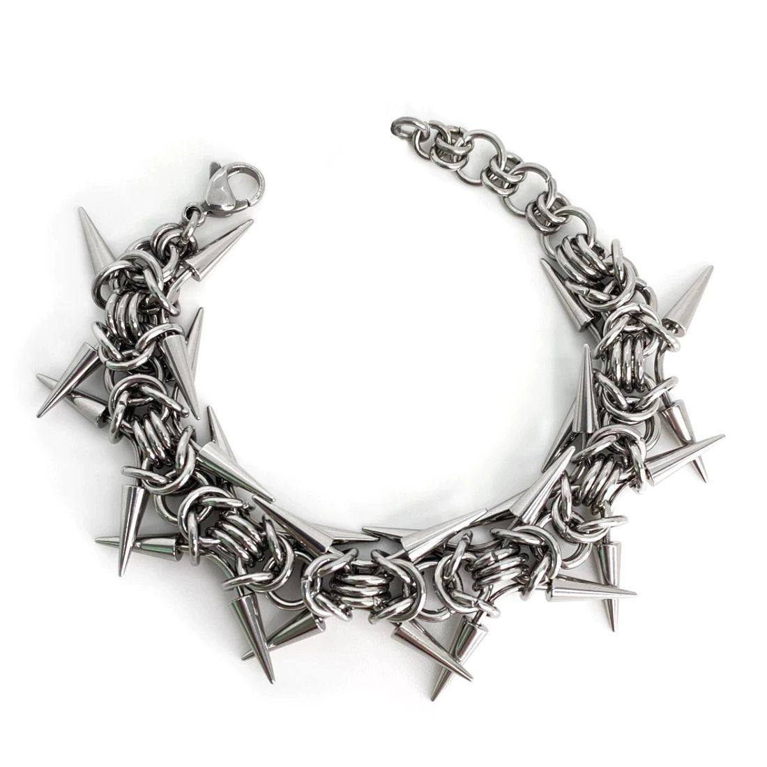 Close up of the linked metal rings and cone spikes of a punk bracelet
