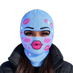 Model in a light blue printed balaclava with pink kiss lips and hearts on a white background