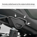 Black plastic shock absorber cover sitting flush on a motorcycle underbody with arrows marking the fit