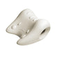Off white moulded EVA neck rest with raised bumps and an oval opening in one wing
