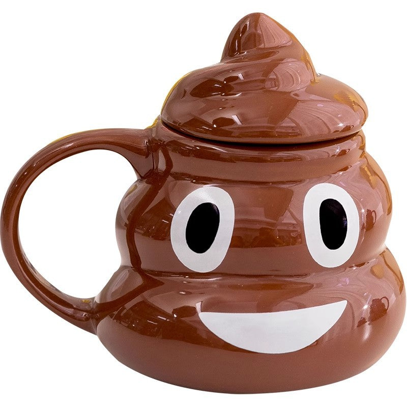 Brown poop emoji ceramic mug with a wide toothy smiley face and matching pointed lid