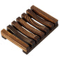 Charred pine wood slatted soap rack with dark brown grain on a white background