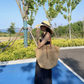 Woven straw tote styled in a bright modern interior with linen and warm tones