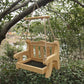 Natural wood bench bird feeder with a mesh floor and a wooden crossbar hanging in a green garden