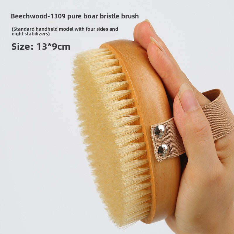 Hand holding the Beech pure boar bristle body brush, standard handheld model, with a caption of 13 by 9 cm