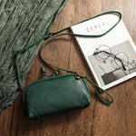 Detail shot of the cowhide finish and strap attachment on the retro leather shoulder bag