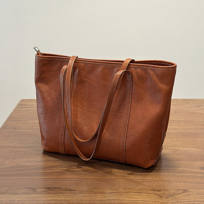 Soft cowhide leather tote bag in brown, front view showing twin rolled handles and open top