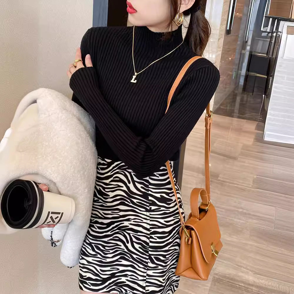 Ribbed mock neck long sleeve knit pullover shown on a model in a soft macaron color