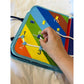 Baby holding the open cloth activity book during play