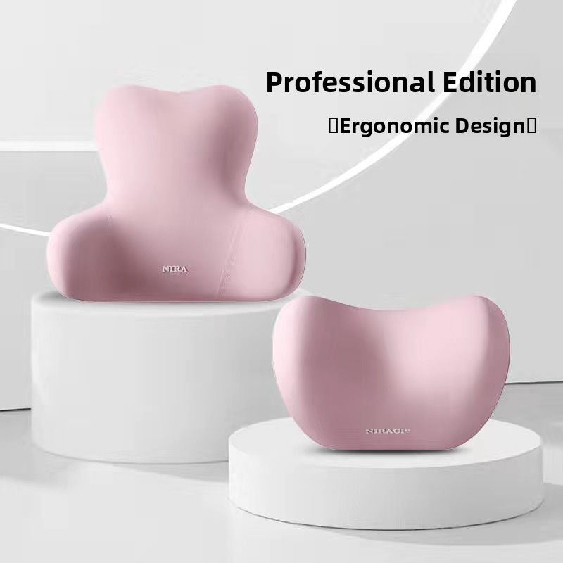 Pink contoured lumbar back cushion and neck headrest pair on white podium