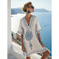 Loose V neck bohemian beach cover up dress in a bohemian border print, worn in the sea breeze at a resort