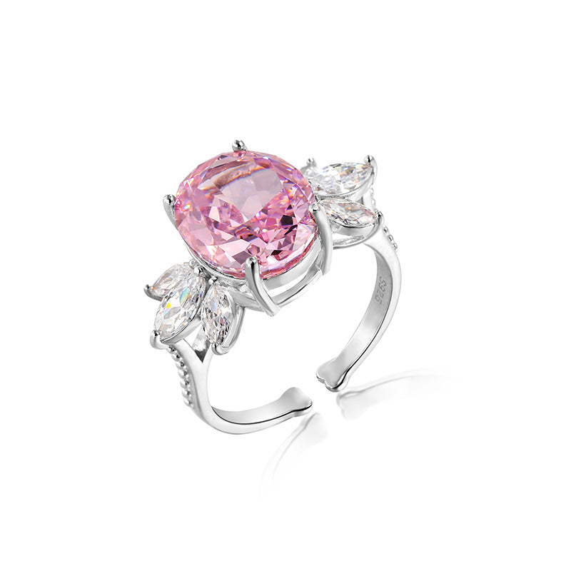 Pink oval simulated diamond framed by a clear marquise cluster on an adjustable silver toned band