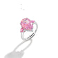 Pear cut pink simulated diamond ring with a small pink accent stone on an adjustable shank