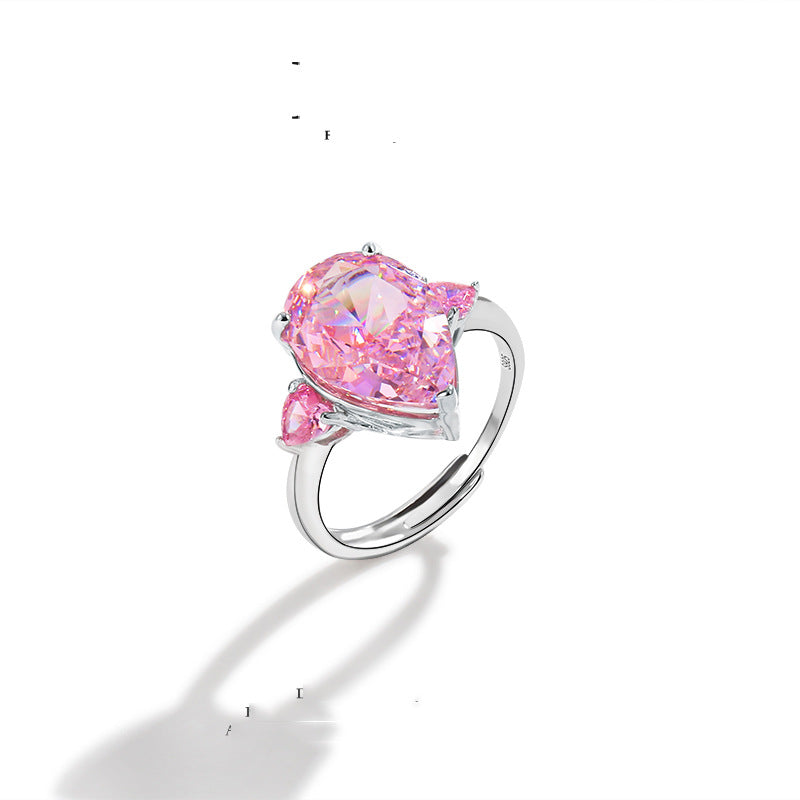 Pear cut pink simulated diamond ring with a small pink accent stone on an adjustable shank