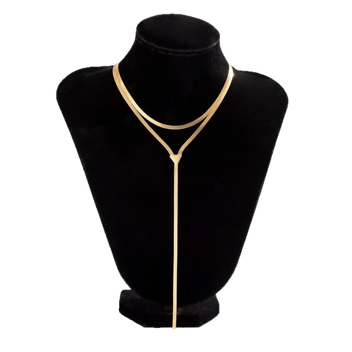 Gold tone layered snake chain lariat necklace displayed on a black bust stand