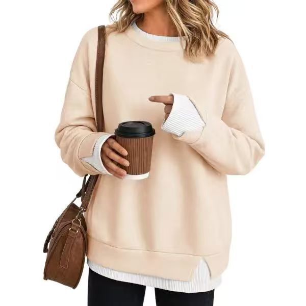 Detail of the contrast white ribbed cuff on a navy striped pullover sweatshirt