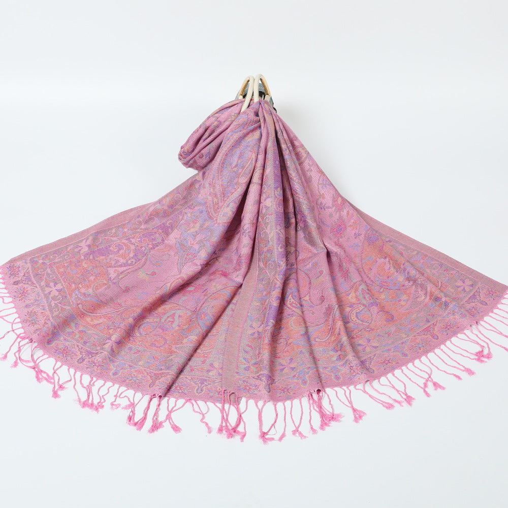 Pink paisley jacquard scarf spread on a white background with twisted pink tassel fringe
