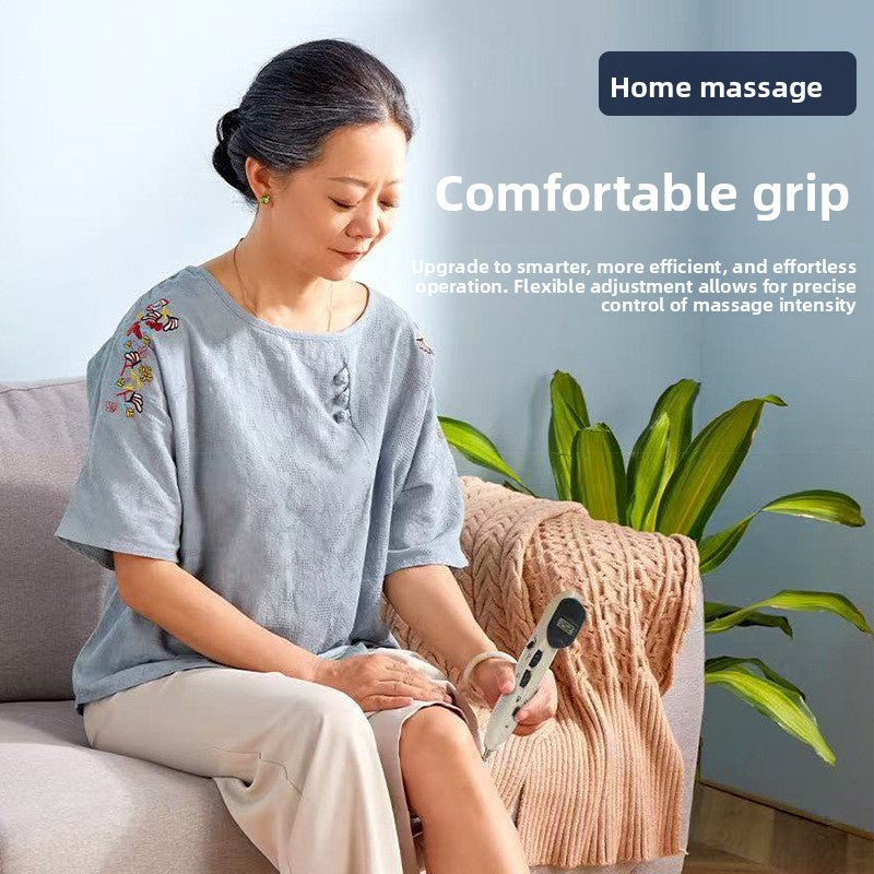 Woman seated on a sofa holding the off white massage pen in both hands, text banner reading comfortable grip